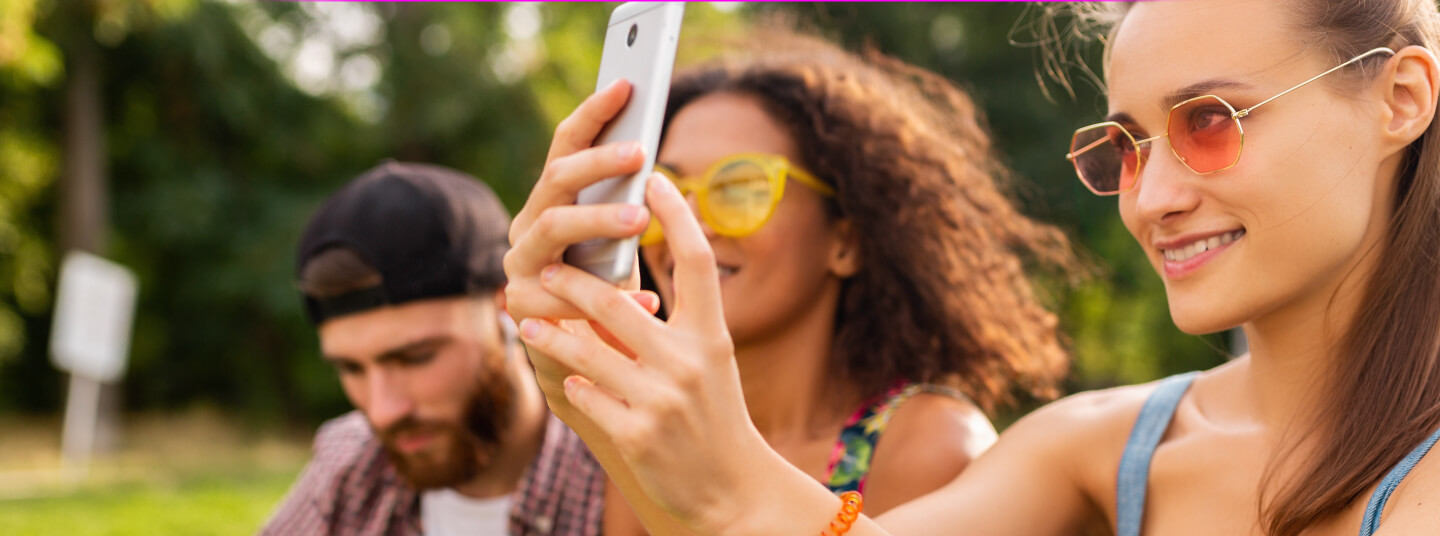 Three young friends using LivU to meet new people from around the world